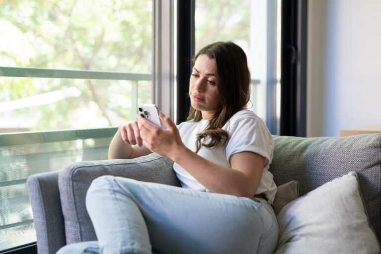 young woman sitting and texting a guy